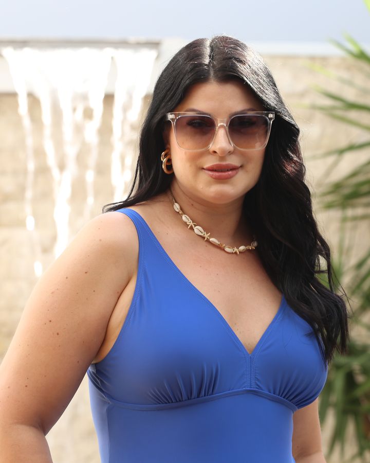 Modelo plus size de maiô azul com decote em V